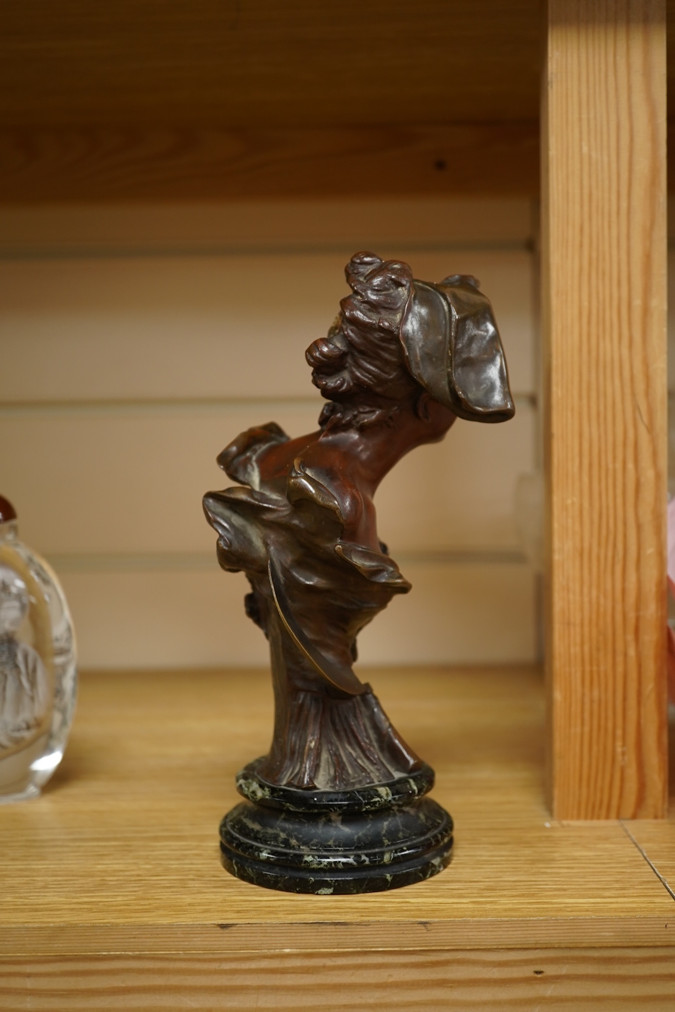 A late 19th century bronze bust of a lady in a hat with floral decoration , mounted on marble, signed, 21.5cm high.